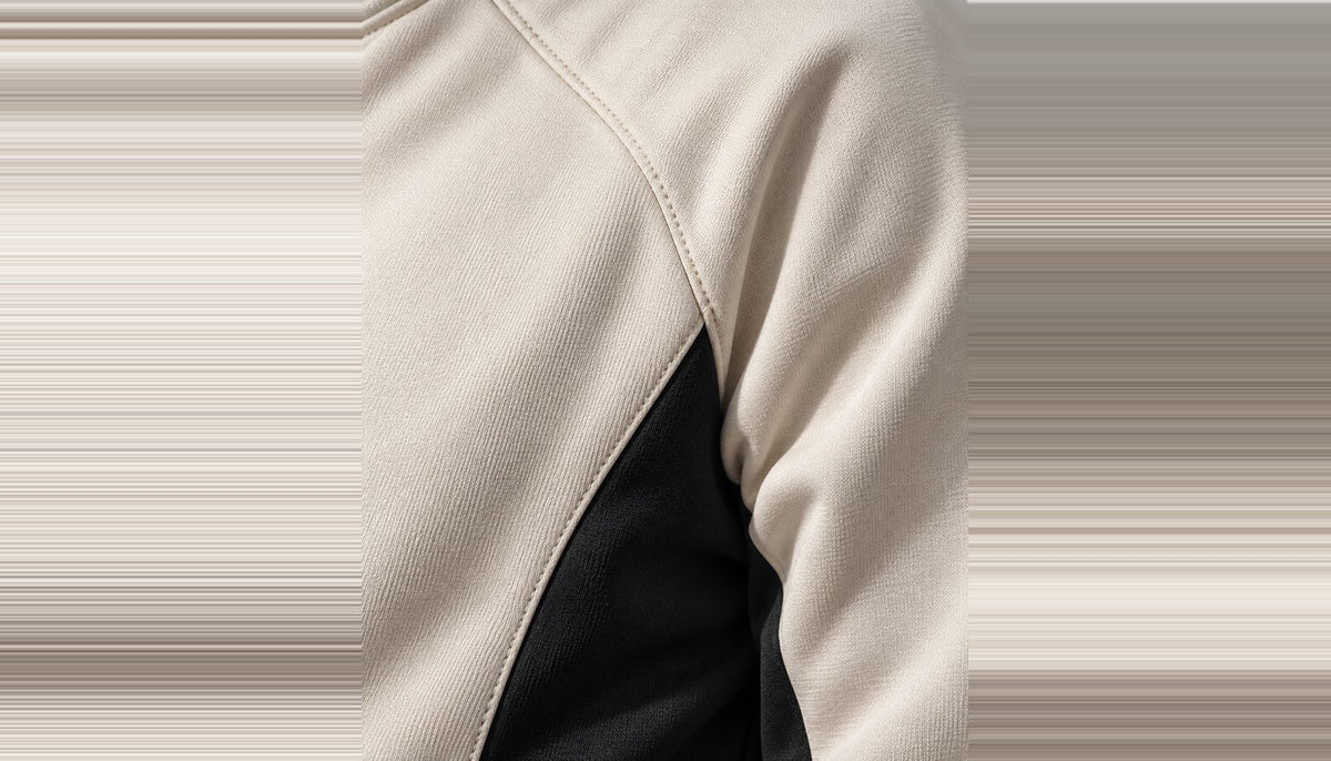 Gros plan sur la couture raglan à l'endroit où elle rejoint le panneau latéral encre.